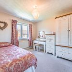 Bedroom detail showcasing quality furnishings and neutral styling within a four-bedroom detached home in Kingsmead.