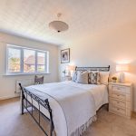 Bright double bedroom within a detached family home in Kingsmead, Northwich featuring neutral décor, fitted furniture and garden views