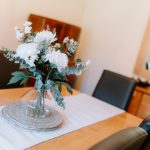 Dining table styling detail with floral centrepiece and entertaining space within a detached family home in Kingsmead