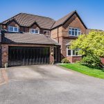Front elevation of a four-bedroom detached family home with double garage and driveway in Kingsmead, Northwich