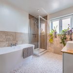 Luxury family bathroom featuring a freestanding bath, walk-in shower and modern fittings.