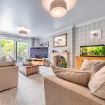 Elegant living room with feature fireplace, contemporary décor and French doors leading to the garden.