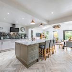 Stylish open-plan kitchen with central island, breakfast bar and integrated appliances at 5 Woburn Close, Kingsmead.