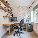 Versatile snug currently arranged as a home office with fitted shelving and views to the front of the property.