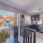 Modern kitchen and dining area with French doors opening onto the rear garden at 9 Hartshill Close, Northwich.
