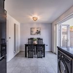 Modern kitchen dining room with French doors opening onto the landscaped rear garden at 9 Harthill Close, Kingsmead.