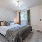 Generous principal bedroom with stylish décor and fitted wardrobes at 9 Harthill Close, Kingsmead.