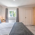 Comfortable principal bedroom with front-facing window and modern décor at 9 Harthill Close, Northwich.