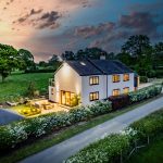 Rear aerial twilight view of Brooklyn Cottage in Lostock Green highlighting landscaped gardens and countryside surroundings.