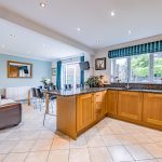 Spacious open-plan kitchen and family room with French doors opening onto the rear garden at 1 Earls Way, Kingsmead.