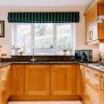 Oak kitchen with granite worktops, integrated appliances and window overlooking the rear garden at 1 Earls Way, Kingsmead.