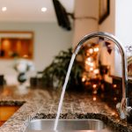 Granite worktops and sink within the open-plan family kitchen at 1 Earls Way, Kingsmead.