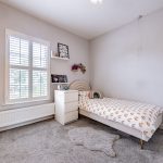 Generous second bedroom with fitted shutters, soft neutral décor and space for freestanding bedroom furniture at 31 Hartford Road, Davenham.
