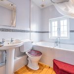 Family bathroom with bath and traditional fittings at The Hollies in Moulton, Cheshire.