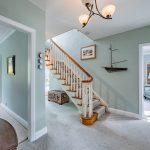 Welcoming entrance hall and sweeping staircase at The Poplars, a substantial detached home on Cockpit Lane in Sandiway.