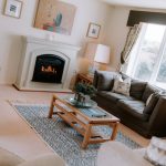Comfortable lounge at The Poplars with feature fireplace and windows overlooking the surrounding Sandiway countryside.
