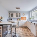 Bright kitchen with extensive storage, breakfast bar and connection towards the conservatory at 25 Hadrian Way, Sandiway.