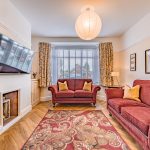 Beautifully presented living room with bay window, feature fireplace and generous seating area at 56 Green Avenue, Davenham.