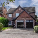 Front exterior of 3 Monarch Drive showing the double garage, generous driveway and landscaped front garden