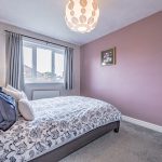 Well-proportioned second bedroom with feature wall at 6 Harvest Close, Moulton
