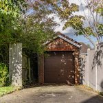 Detached brick-built single garage with private driveway, mature trees and established planting in Kingsmead.